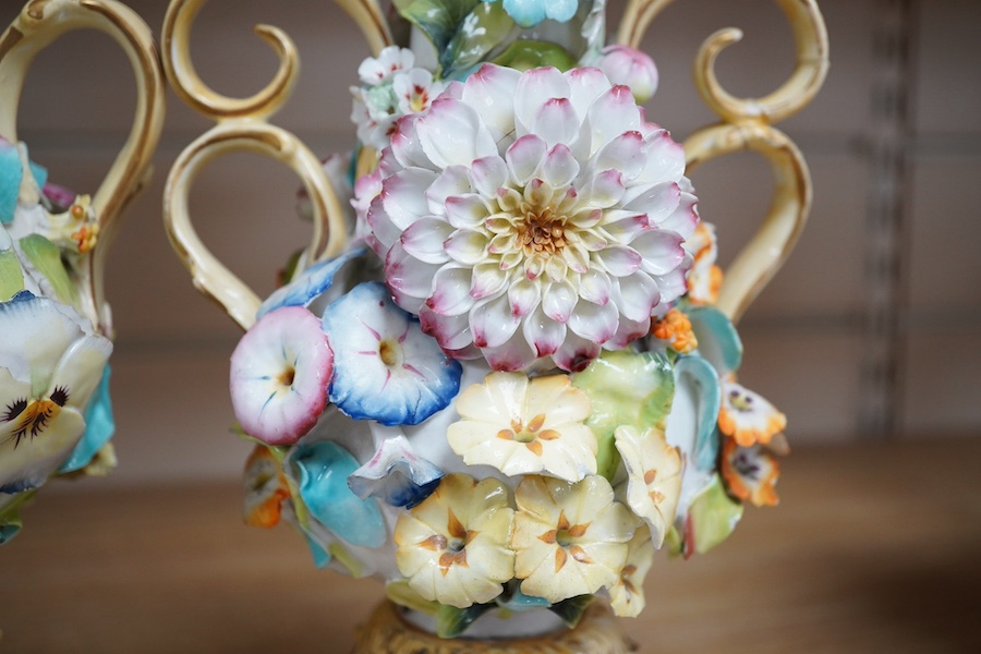 A Coalport garniture vase set with applied flowers, tallest 31cm. Condition - restored